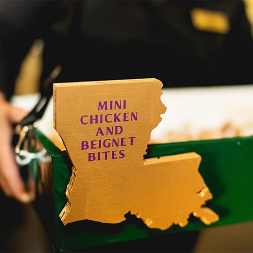 Mini Chicken and Beignet Bites Signage on food tray at Mardi Gras Party